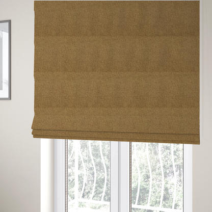 The fabric used to create these Roman blinds is a golden brown or mustard fabric featuring a distinct, tightly woven grid texture. The material showcases a multi-tonal, basket-weave style pattern with blended ochre and tan threads, creating a warm, vibrant, and matte finish across the entire surface.