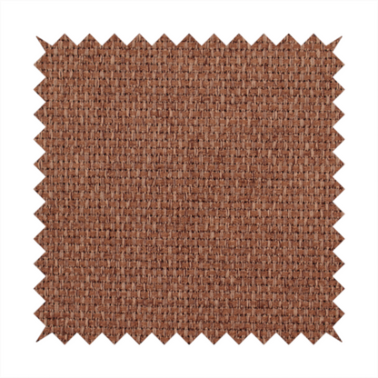 A rust or terracotta-brown fabric featuring a distinct, tightly woven grid texture. The material showcases a multi-tonal, basket-weave style pattern with interlaced copper and warm brown threads, creating a rich, earthy, and matte finish across the entire surface.