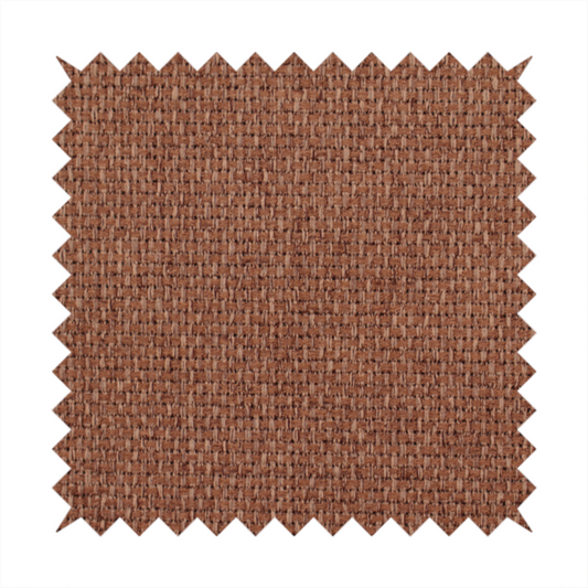 A rust or terracotta-brown fabric featuring a distinct, tightly woven grid texture. The material showcases a multi-tonal, basket-weave style pattern with interlaced copper and warm brown threads, creating a rich, earthy, and matte finish across the entire surface.