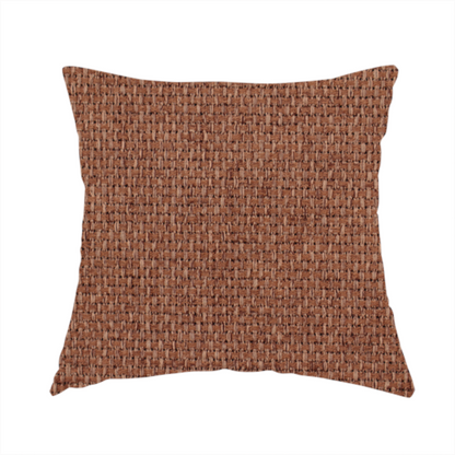 The fabric used to create this handmade cushion is a rust or terracotta-brown fabric featuring a distinct, tightly woven grid texture. The material showcases a multi-tonal, basket-weave style pattern with interlaced copper and warm brown threads, creating a rich, earthy, and matte finish across the entire surface.