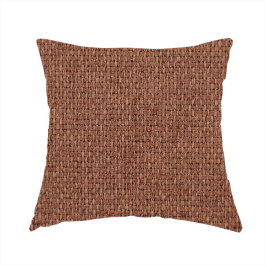 The fabric used to create this handmade cushion is a rust or terracotta-brown fabric featuring a distinct, tightly woven grid texture. The material showcases a multi-tonal, basket-weave style pattern with interlaced copper and warm brown threads, creating a rich, earthy, and matte finish across the entire surface.