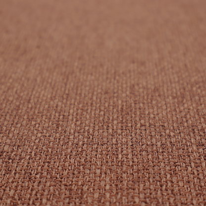 A rust or terracotta-brown fabric featuring a distinct, tightly woven grid texture. The material showcases a multi-tonal, basket-weave style pattern with interlaced copper and warm brown threads, creating a rich, earthy, and matte finish across the entire surface.