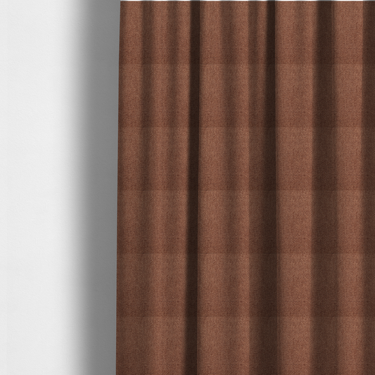 The fabric used to create these made-to-measure curtains is a rust or terracotta-brown fabric featuring a distinct, tightly woven grid texture. The material showcases a multi-tonal, basket-weave style pattern with interlaced copper and warm brown threads, creating a rich, earthy, and matte finish across the entire surface.