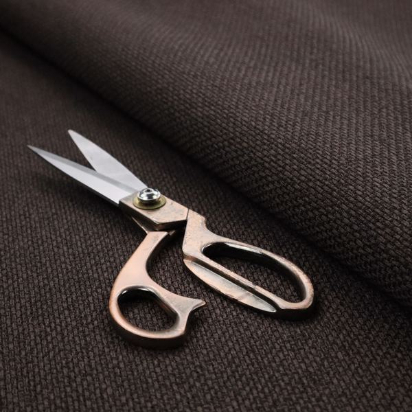 A dark chocolate or espresso brown fabric featuring a distinct, tightly woven grid texture. The material showcases a deep, multi-tonal, basket-weave style pattern with interlaced charcoal and dark brown threads, creating a rich, moody, and matte finish across the entire surface.