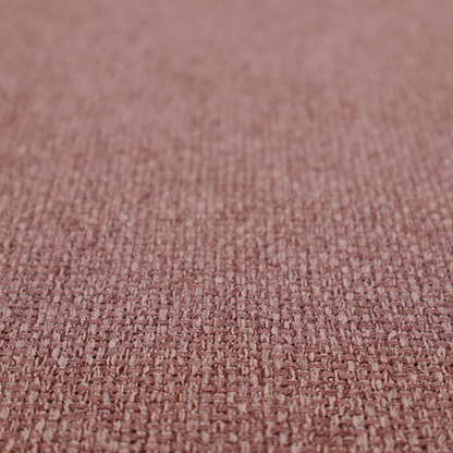 A dusty rose or mauve fabric featuring a distinct, tightly woven grid texture. The material showcases a multi-tonal, basket-weave style pattern with blended pinkish-brown and muted rose threads, creating a soft, sophisticated, and matte finish across the entire surface.