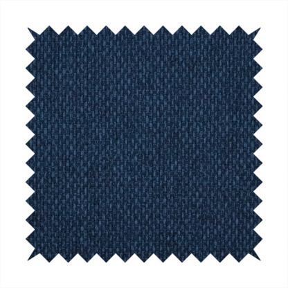 A deep navy or indigo blue fabric featuring a distinct, tightly woven grid texture. The material showcases a multi-tonal, basket-weave style pattern with blended dark blue and subtle charcoal threads, creating a rich, classic, and matte finish across the entire surface.