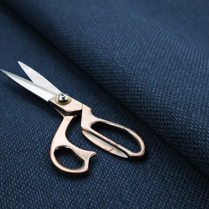 A deep navy or indigo blue fabric featuring a distinct, tightly woven grid texture. The material showcases a multi-tonal, basket-weave style pattern with blended dark blue and subtle charcoal threads, creating a rich, classic, and matte finish across the entire surface.