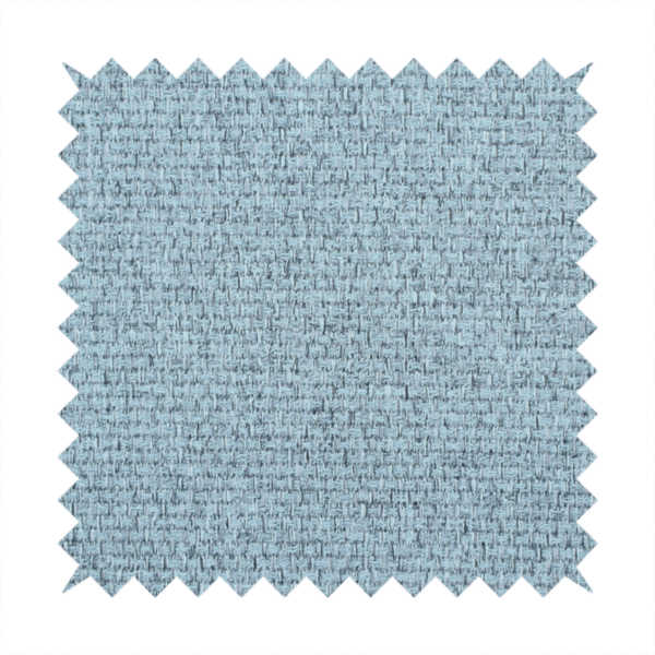 A light ice blue or pastel blue fabric featuring a distinct, tightly woven grid texture. The material showcases a multi-tonal, basket-weave style pattern with blended sky blue and subtle grey threads, creating a fresh, serene, and matte finish across the entire surface.