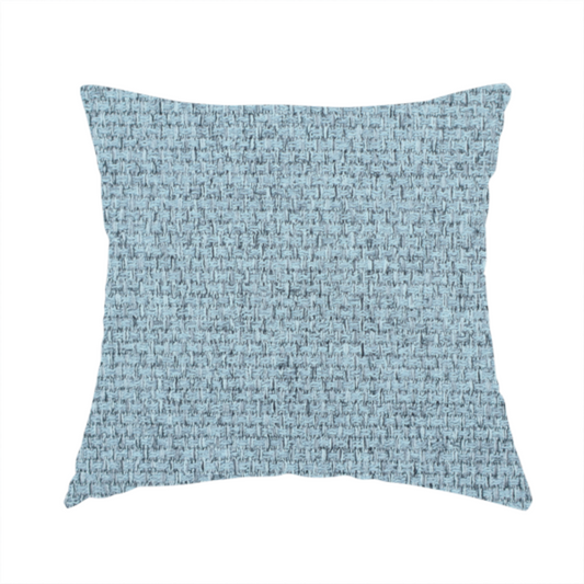 The fabric used to create this handmade cushion is a light ice blue or pastel blue fabric featuring a distinct, tightly woven grid texture. The material showcases a multi-tonal, basket-weave style pattern with blended sky blue and subtle grey threads, creating a fresh, serene, and matte finish across the entire surface.