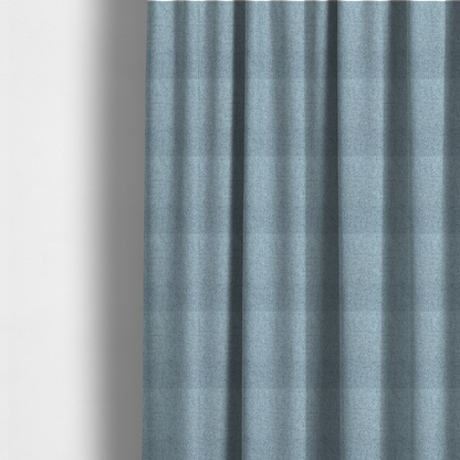 The fabric used to create these made-to-measure curtains is a light ice blue or pastel blue fabric featuring a distinct, tightly woven grid texture. The material showcases a multi-tonal, basket-weave style pattern with blended sky blue and subtle grey threads, creating a fresh, serene, and matte finish across the entire surface.