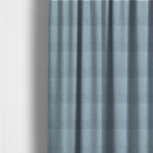 The fabric used to create these made-to-measure curtains is a light ice blue or pastel blue fabric featuring a distinct, tightly woven grid texture. The material showcases a multi-tonal, basket-weave style pattern with blended sky blue and subtle grey threads, creating a fresh, serene, and matte finish across the entire surface.