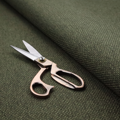 A deep olive or moss green fabric featuring a distinct, tightly woven grid texture. The material showcases a rich, multi-tonal, basket-weave style pattern with interlaced forest green and muted earthy threads, creating a natural, sophisticated, and matte finish across the entire surface.