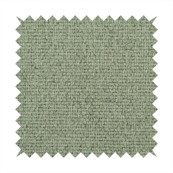 A light sage or mint green fabric featuring a distinct, tightly woven grid texture. The material showcases a multi-tonal, basket-weave style pattern with blended pale green and subtle grey threads, creating a fresh, calming, and matte finish across the entire surface.