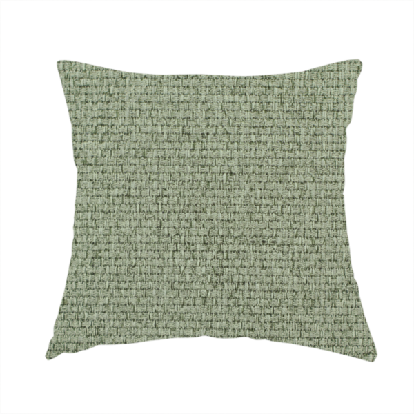 The fabric used to create this handmade cushion is a light sage or mint green fabric featuring a distinct, tightly woven grid texture. The material showcases a multi-tonal, basket-weave style pattern with blended pale green and subtle grey threads, creating a fresh, calming, and matte finish across the entire surface.