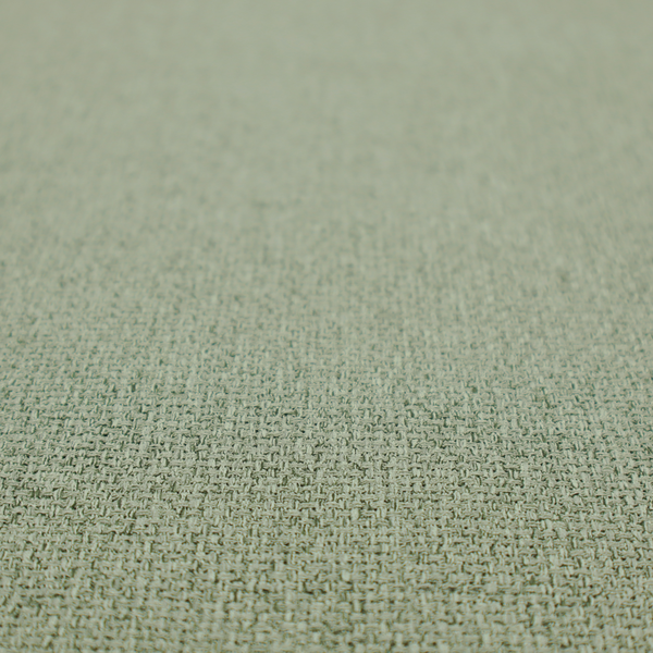 A light sage or mint green fabric featuring a distinct, tightly woven grid texture. The material showcases a multi-tonal, basket-weave style pattern with blended pale green and subtle grey threads, creating a fresh, calming, and matte finish across the entire surface.