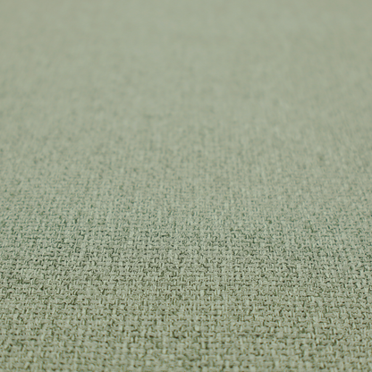 A light sage or mint green fabric featuring a distinct, tightly woven grid texture. The material showcases a multi-tonal, basket-weave style pattern with blended pale green and subtle grey threads, creating a fresh, calming, and matte finish across the entire surface.