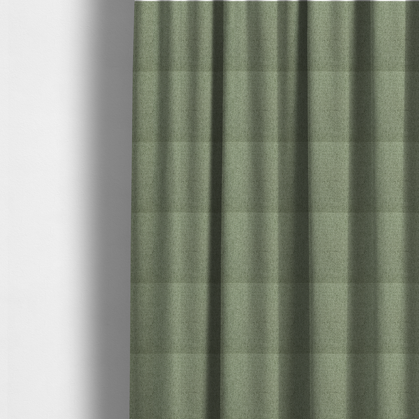 The fabric used to create these made-to-measure curtains is a light sage or mint green fabric featuring a distinct, tightly woven grid texture. The material showcases a multi-tonal, basket-weave style pattern with blended pale green and subtle grey threads, creating a fresh, calming, and matte finish across the entire surface.