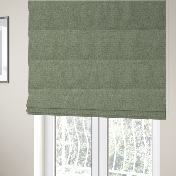The fabric used to create these Roman blinds is a light sage or mint green fabric featuring a distinct, tightly woven grid texture. The material showcases a multi-tonal, basket-weave style pattern with blended pale green and subtle grey threads, creating a fresh, calming, and matte finish across the entire surface.