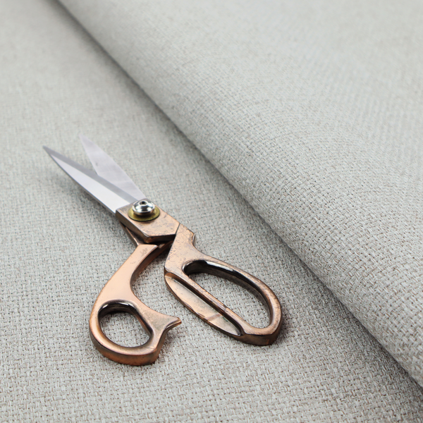 A light silver-grey or ash-grey fabric featuring a distinct, tightly woven grid texture. The material showcases a multi-tonal, basket-weave style pattern with blended cool grey and subtle pale threads, creating a clean, neutral, and matte finish across the entire surface.