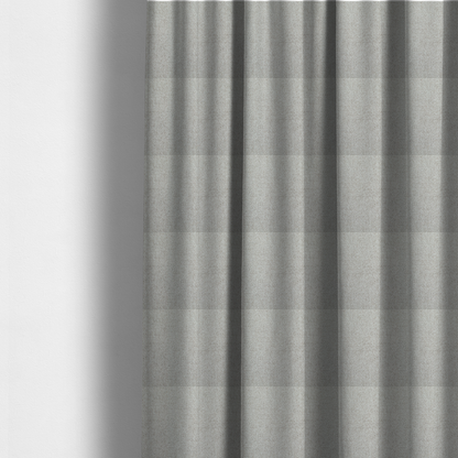 The fabric used to create these made-to-measure curtains is a light silver-grey or ash-grey fabric featuring a distinct, tightly woven grid texture. The material showcases a multi-tonal, basket-weave style pattern with blended cool grey and subtle pale threads, creating a clean, neutral, and matte finish across the entire surface.