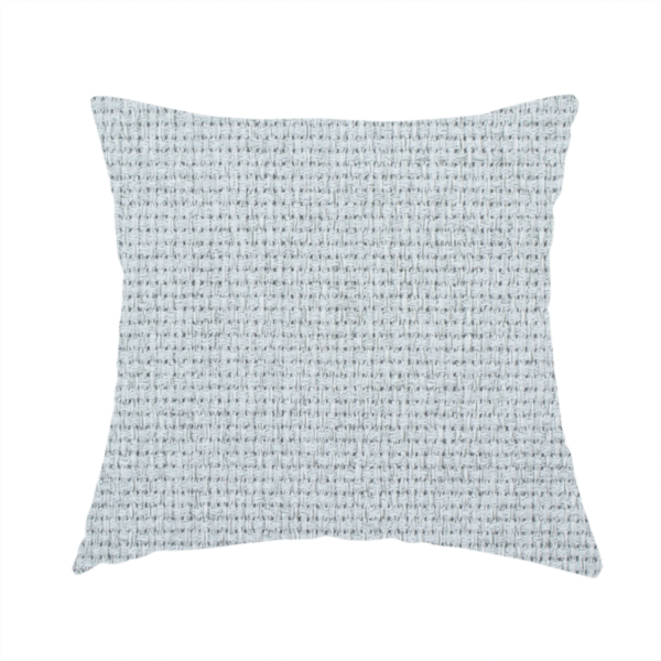 The fabric used to create this handmade cushion is a very light ice-grey or tinted white fabric featuring a distinct, tightly woven grid texture. The material showcases a multi-tonal, basket-weave style pattern with blended pale silver and crisp off-white threads, creating a bright, minimalist, and matte finish across the entire surface.