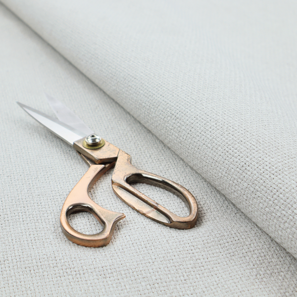 A light grey or soft ash fabric featuring a distinct, tightly woven grid texture. The material showcases a multi-tonal, basket-weave style pattern with blended pale grey and subtle white threads, creating a clean, neutral, and matte finish across the entire surface.