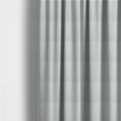 The fabric used to create these made-to-measure curtains is a light grey or soft ash fabric featuring a distinct, tightly woven grid texture. The material showcases a multi-tonal, basket-weave style pattern with blended pale grey and subtle white threads, creating a clean, neutral, and matte finish across the entire surface.