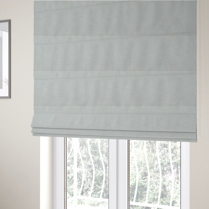 The fabric used to create these Roman blinds is a light grey or soft ash fabric featuring a distinct, tightly woven grid texture. The material showcases a multi-tonal, basket-weave style pattern with blended pale grey and subtle white threads, creating a clean, neutral, and matte finish across the entire surface.