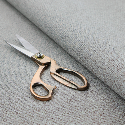 A mid-grey or stone-grey fabric featuring a distinct, tightly woven grid texture. The material showcases a multi-tonal, basket-weave style pattern with blended cool grey, taupe, and subtle white threads, creating a grounded, textured neutral, and matte finish across the entire surface.