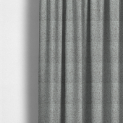 The fabric used to create these made-to-measure curtains is a mid-grey or stone-grey fabric featuring a distinct, tightly woven grid texture. The material showcases a multi-tonal, basket-weave style pattern with blended cool grey, taupe, and subtle white threads, creating a grounded, textured neutral, and matte finish across the entire surface.