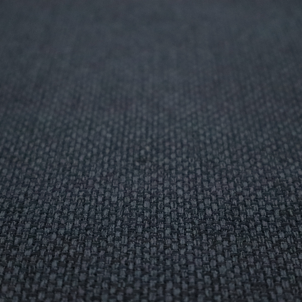 A dark charcoal-grey or slate fabric featuring a distinct, tightly woven grid texture. The material showcases a rich, multi-tonal, basket-weave style pattern with blended deep grey, subtle navy, and black threads, creating a moody, sophisticated, and matte finish across the entire surface.