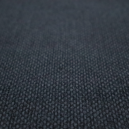 A dark charcoal-grey or slate fabric featuring a distinct, tightly woven grid texture. The material showcases a rich, multi-tonal, basket-weave style pattern with blended deep grey, subtle navy, and black threads, creating a moody, sophisticated, and matte finish across the entire surface.