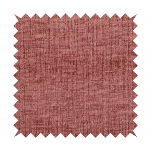 A textured upholstery fabric in a dusty rose or terracotta pink colour. The fabric features a raised, cross-hatched slub texture with subtle vertical and horizontal ridges, giving it a cosy, slightly distressed chenille appearance.