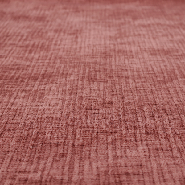 A textured upholstery fabric in a dusty rose or terracotta pink colour. The fabric features a raised, cross-hatched slub texture with subtle vertical and horizontal ridges, giving it a cosy, slightly distressed chenille appearance.