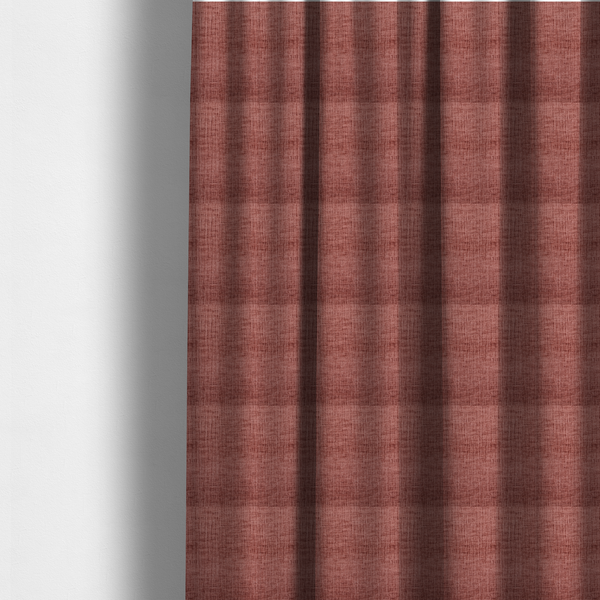 The fabric used to create these made-to-measure curtains is a textured upholstery fabric in a dusty rose or terracotta pink colour. The fabric features a raised, cross-hatched slub texture with subtle vertical and horizontal ridges, giving it a cosy, slightly distressed chenille appearance.