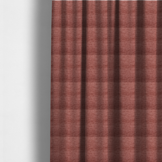 The fabric used to create these made-to-measure curtains is a textured upholstery fabric in a dusty rose or terracotta pink colour. The fabric features a raised, cross-hatched slub texture with subtle vertical and horizontal ridges, giving it a cosy, slightly distressed chenille appearance.
