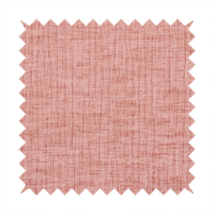 A textured upholstery fabric in a soft, light blush pink shade. The material features a distinctive cross-hatched slub texture with fine vertical and horizontal ridges, creating a plush, tactile chenille finish.