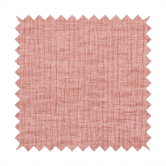 A textured upholstery fabric in a soft, light blush pink shade. The material features a distinctive cross-hatched slub texture with fine vertical and horizontal ridges, creating a plush, tactile chenille finish.