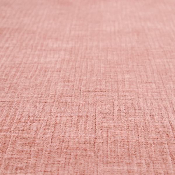 A textured upholstery fabric in a soft, light blush pink shade. The material features a distinctive cross-hatched slub texture with fine vertical and horizontal ridges, creating a plush, tactile chenille finish.