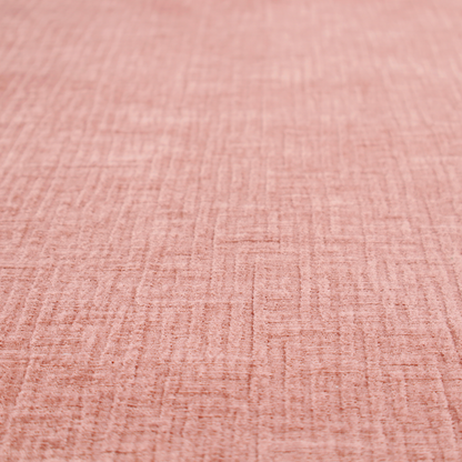 A textured upholstery fabric in a soft, light blush pink shade. The material features a distinctive cross-hatched slub texture with fine vertical and horizontal ridges, creating a plush, tactile chenille finish.