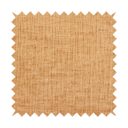 A textured upholstery fabric in a warm, honey-gold or mustard yellow colour. The material features a distinct cross-hatched slub texture with subtle vertical and horizontal ridges, creating a soft, dimensional chenille finish.