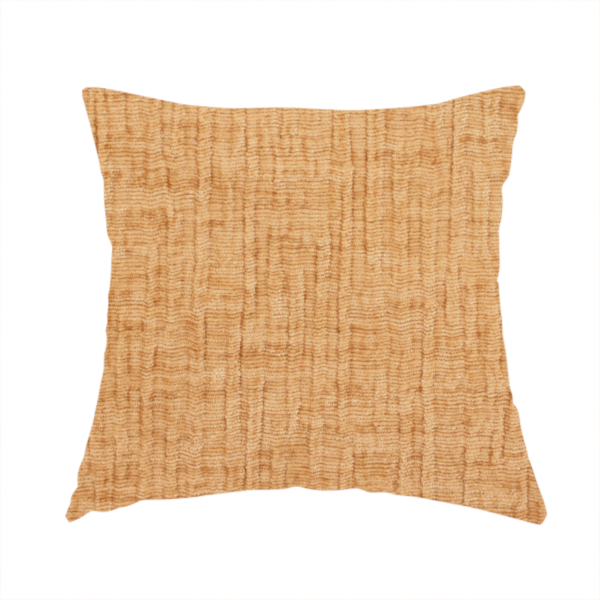 The fabric used to create this handmade cushion is a textured upholstery fabric in a warm, honey-gold or mustard yellow colour. The material features a distinct cross-hatched slub texture with subtle vertical and horizontal ridges, creating a soft, dimensional chenille finish.