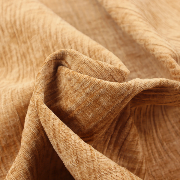 A textured upholstery fabric in a warm, honey-gold or mustard yellow colour. The material features a distinct cross-hatched slub texture with subtle vertical and horizontal ridges, creating a soft, dimensional chenille finish.