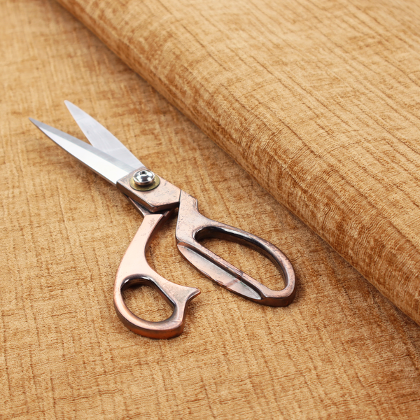 A textured upholstery fabric in a warm, honey-gold or mustard yellow colour. The material features a distinct cross-hatched slub texture with subtle vertical and horizontal ridges, creating a soft, dimensional chenille finish.