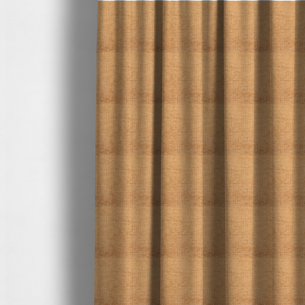The fabric used to create these made-to-measure curtains is a textured upholstery fabric in a warm, honey-gold or mustard yellow colour. The material features a distinct cross-hatched slub texture with subtle vertical and horizontal ridges, creating a soft, dimensional chenille finish.
