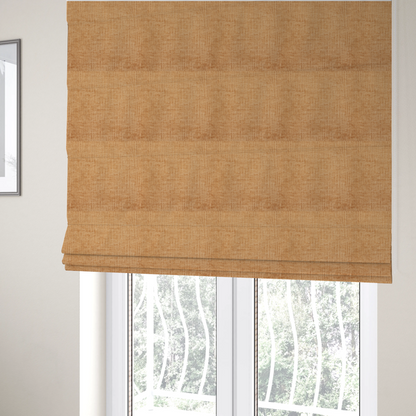 The fabric used to create these Roman blinds is a textured upholstery fabric in a warm, honey-gold or mustard yellow colour. The material features a distinct cross-hatched slub texture with subtle vertical and horizontal ridges, creating a soft, dimensional chenille finish.
