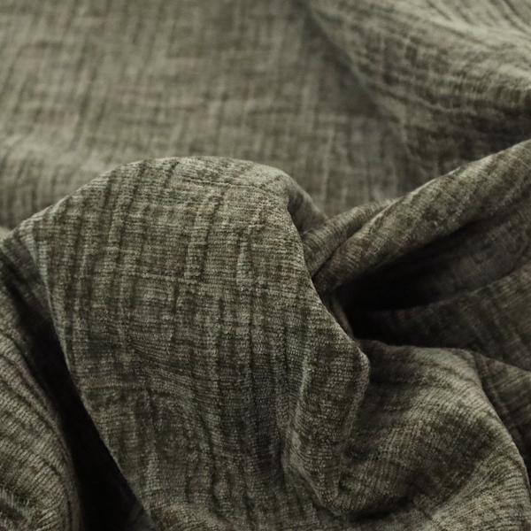 A textured upholstery fabric in an earthy olive or sage green colour. The material features a prominent cross-hatched slub texture with subtle horizontal and vertical ridges, giving it a cosy, multi-dimensional chenille appearance.