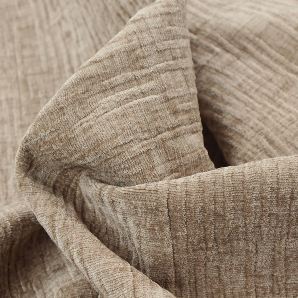 A textured upholstery fabric in a warm, neutral beige or oatmeal colour. The material features a distinct cross-hatched slub texture with fine vertical and horizontal ridges, creating a soft, dimensional chenille finish.
