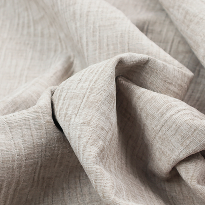 A textured upholstery fabric in a light cream or ivory colour. The material features a subtle cross-hatched slub texture with fine vertical and horizontal ridges, creating a soft, dimensional chenille finish.