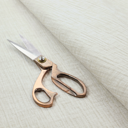 A textured upholstery fabric in a clean white or light ivory colour. The material features a subtle cross-hatched slub texture with fine vertical and horizontal ridges, creating a soft, dimensional chenille finish.